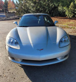 Front view of a silver 2005 Chevrolet Corvette, showcasing its sleek design and headlights.