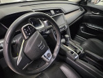Interior view of a well-maintained 2016 Honda Civic Touring with leather seats and premium features.