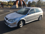 2003 Mazda Protege 5 in silver color, showing slight dents and wear, parked outdoors