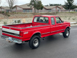 Red 1997 Ford F250 truck with 7.3 Powerstroke engine and 5-speed transmission parked outdoors