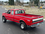 1997 Ford F250 in red, 4-wheel drive, 7.3 Powerstroke engine, well-maintained with 257,000 miles.