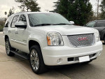 2007 GMC Yukon Denali AWD in white, V8 engine, alloy wheels, clean condition, perfect for families.