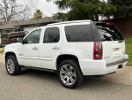 2007 GMC Yukon Denali AWD in white, displaying premium chrome wheels and clean exterior