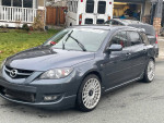 2009 MAZDASPEED 3 in gray color, fully modified, showcasing unique wheels and sporty design.