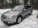 2010 Subaru Outback in silver parked in snow, clean, low mileage, senior-owned, top premium model.