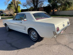 1966 Ford Mustang in Wimbledon white with red interior, showcasing classic design and excellent condition.