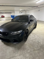 Modified 2018 BMW M2 F87 in parking lot with winter tires and stock parts included.