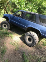 2007 Toyota 4Runner on rough terrain, equipped for off-road adventures, showcasing its modifications and rugged tires.