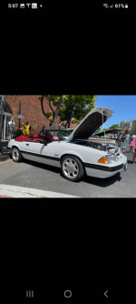 Clean 1989 Ford Mustang LX convertible with 5.0 engine and Eibach springs parked at car event.