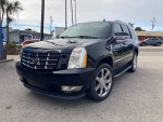 Black Cadillac Escalade showcased in a parking lot, highlighting its luxury design and features.