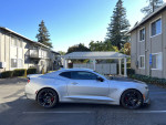 2018 Chevrolet Camaro 1SS in silver, showcasing performance features and sporty design parked near an apartment complex.