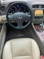 Interior view of a 2010 Lexus IS 250 showing dashboard, steering wheel, and seats.