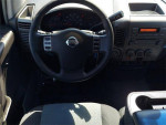 Interior view of Nissan Titan 4x4 with steering wheel, dashboard, and multimedia controls.