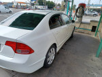 White Honda Civic parked at gas station, excellent condition, recently serviced, low mileage