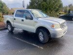2008 Ford F150 XLT 4X4 pickup truck with silver body parked on the street
