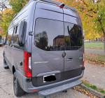 Rear view of a 2023 Mercedes-Benz Sprinter van, showcasing sleek design and ample space for travel.