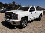 2014 Chevrolet Silverado 1500 LT 4WD in white with chrome accents, parked in a gravel lot