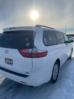 2015 Toyota Sienna LE AWD parked in snowy conditions, showcasing clean exterior and new Blizzak snow tires.