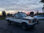 1990 Ford F-250 XLT Lariat 4WD parked at sunset with scenic background and visible details