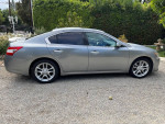 2009 Nissan Maxima in good condition, showcasing sleek design and side profile with leather interior.