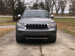 Front view of a 2012 Jeep Grand Cherokee 4x4 Limited with leaf-covered ground.