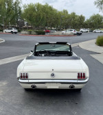 Rear view of a 1965 Ford Mustang Convertible in excellent condition, showcasing its classic design and convertible top.