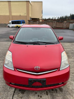 Front view of a red 2007 Toyota Prius with low mileage, ideal for deliveries and economical driving.