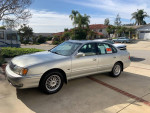 1999 Toyota Avalon XLS FWD parked in front of a house, showcasing its excellent condition and garaged history.