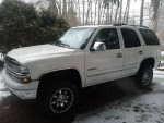 2000 Chevrolet Tahoe parked outside; rust-free, 66,000 miles, 4-inch lift, and tow package.