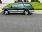2002 Subaru Outback Legacy Series in green color, parked on a road, showcasing clean exterior and original paint.