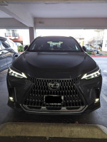 Front view of a 2023 Lexus NX 350h AWD parked, showcasing its distinctive grille and modern design.