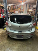 2011 Mazda 3 s Sport Hatchback 4D with custom wheels in a garage setting
