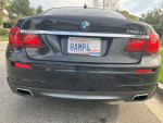 Back view of a black 2015 BMW 750Li M Sport parked with a California license plate.