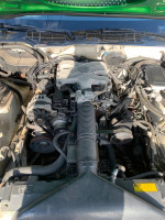 Engine compartment of a 1988 Chevrolet Camaro with a 2.8L V6 and manual transmission.