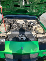 1988 Chevrolet Camaro engine view in custom Slimer green paint, showing its condition and components.