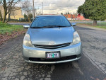 2009 Toyota Prius in silver color with clean exterior, featuring a hybrid battery warranty and 50+ MPG performance.