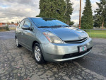 2009 Toyota Prius in silver color, parked outdoors with clean exterior and new tires, offering great fuel efficiency