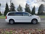 2013 Chrysler Town and Country minivan in white, clean title, low mileage, parked in a scenic area.