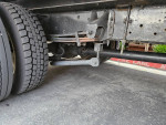 Undercarriage view of a well-maintained GMC C550 truck with new tires, highlighting its solid build.