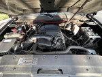 Engine compartment of a 2009 GMC Yukon, showing maintenance details and components