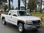 2005 GMC Sierra 2500 HD extended cab with 139,000 miles, clean exterior, well-maintained, parked in a scenic area.
