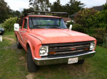 1968 Chevrolet C10 pickup truck with 8' bed, rebuilt engine and new tires, parked in a grassy area.