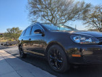 2013 Volkswagen Jetta TDI in black with OEM blacked out wheels parked outdoors
