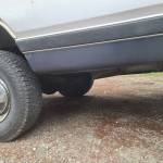 Close-up of the underside and tire of a 1989 Dodge Ram 4x4 truck, showing typical wear and tear.