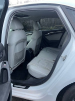 Interior view of a 2013 Audi A4 2.0T Prestige showing spacious back seats and sunroof.