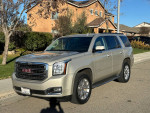 2015 GMC Yukon SLT RWD in excellent condition, featuring power windows, DVD player, and seating for 7 passengers.