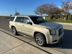 2015 GMC Yukon SLT RWD in beige parked on street with alloy wheels and clear blue sky, ideal family SUV.