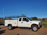 2006 Ford F250 Turbo Diesel 4x4 utility truck, well maintained with new rims and tires.