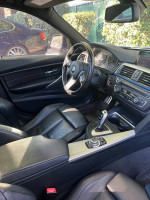 Interior view of a 2013 BMW 328i Xdrive with premium features and black leather seats.