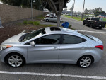 Grey 2013 Hyundai Elantra Limited parked, sunroof open, in good condition with leather and navigation features.